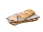 Sagriezta lauku maize uz koka dēlīša ar pelēku dvieli