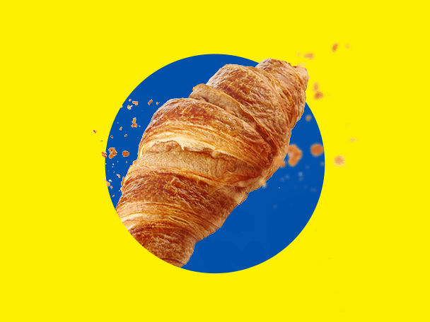 Zeltīts, kraukšķīgs kruasāns uz dzeltena fona ar zilu apli.