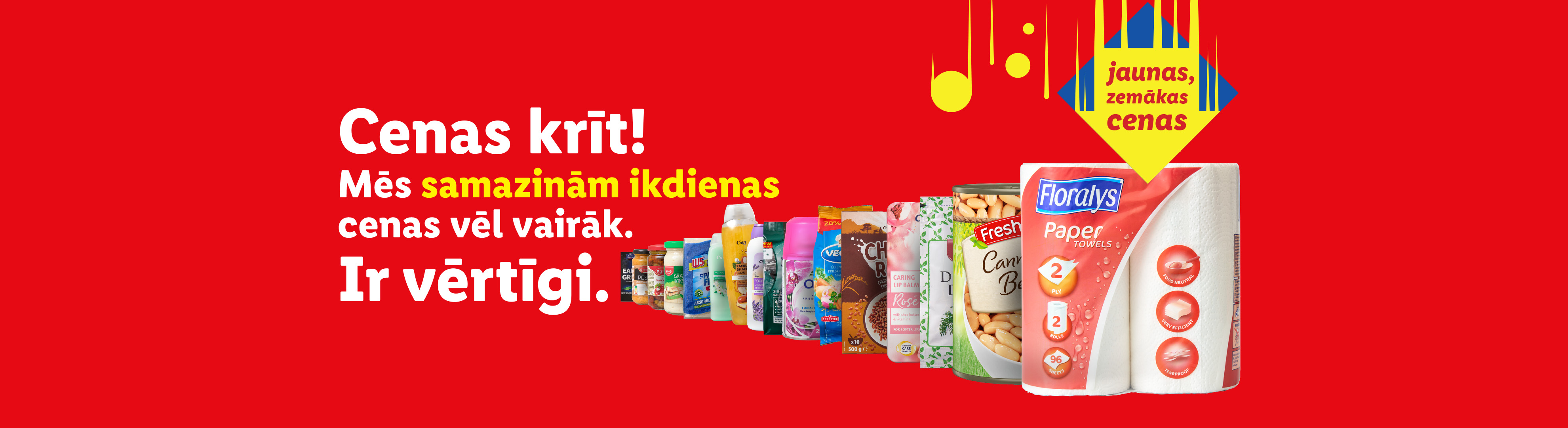Pārtikas un mājsaimniecības preces ar uzrakstu 'Cenas krīt!' un 'jaunas, zemākas cenas'.
