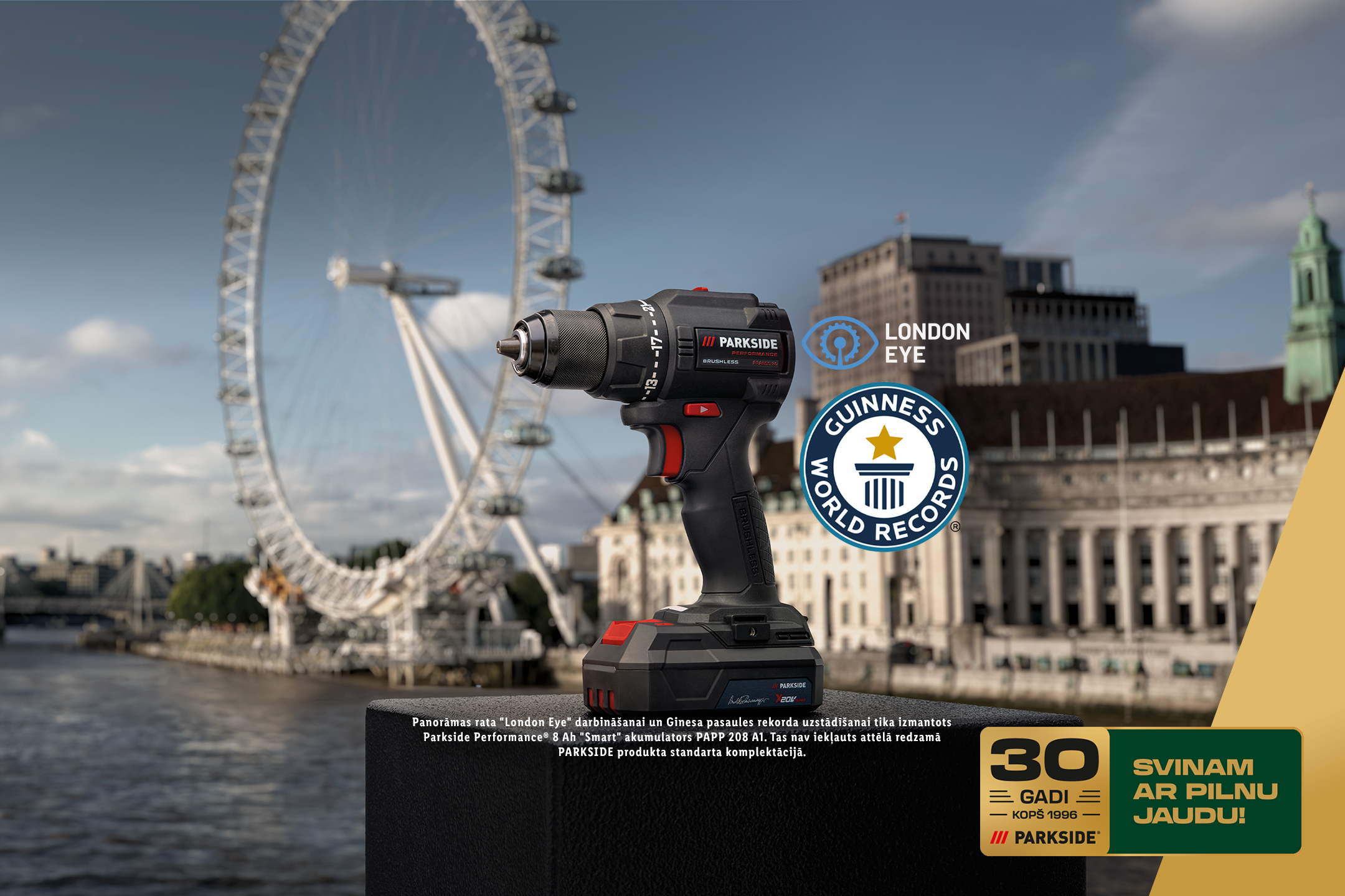 Urbjmašīna ar akumulatoru Londonas panorāmas fonā, ar Ginesa rekorda un London Eye logotipiem, svinot 30 gadus.